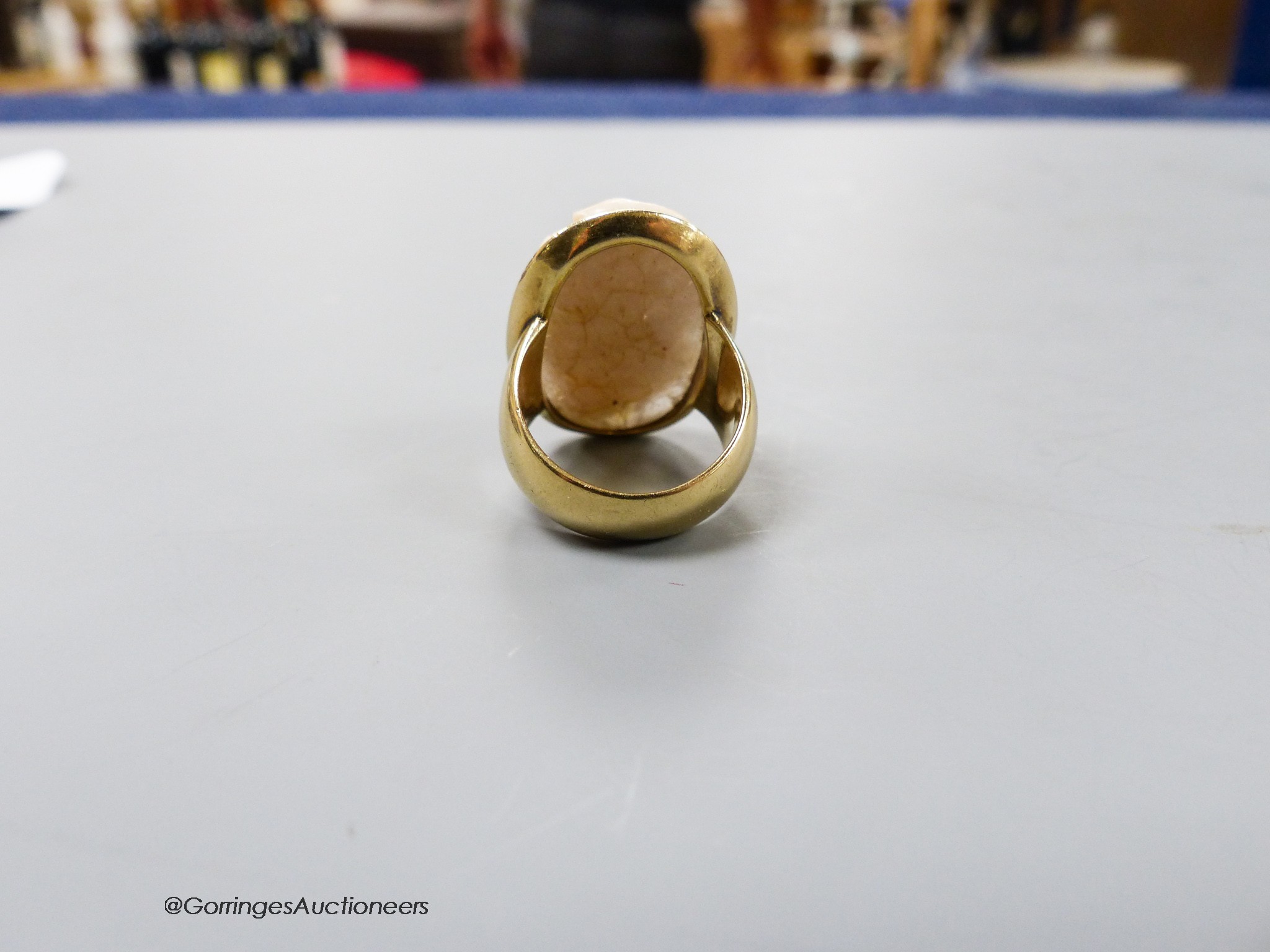 An antique yellow metal and oval cameo quartz? ring, carved with head of a gentlemen to sinister, size K, gross 13.2 grams.